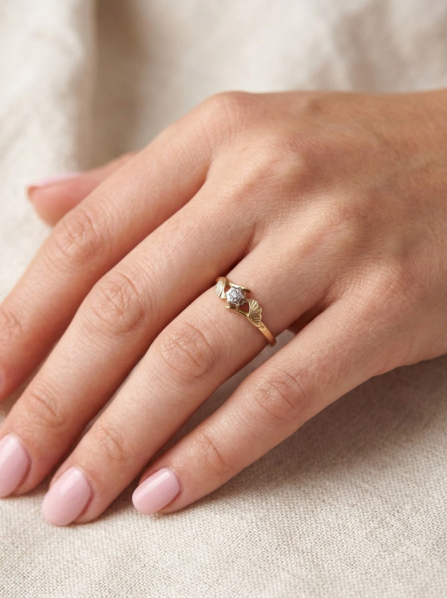 hand A pretty diamond solitaire ring. The diamond 2mm (0.03 carats) and illusion set in platinum.&nbsp; Head overall 4.3mm.