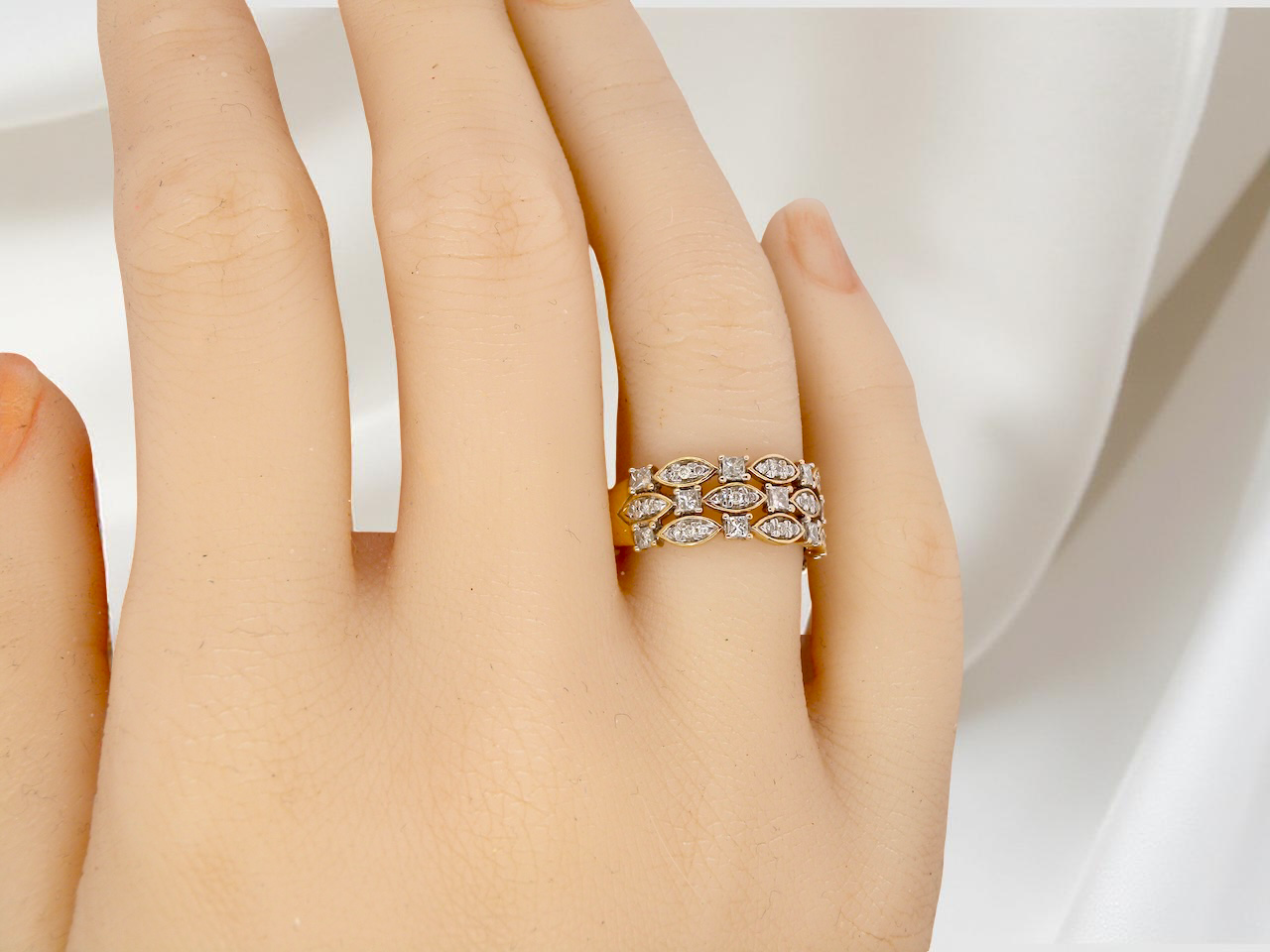 hand A striking half-hoop style ring featuring three diamond-set bands