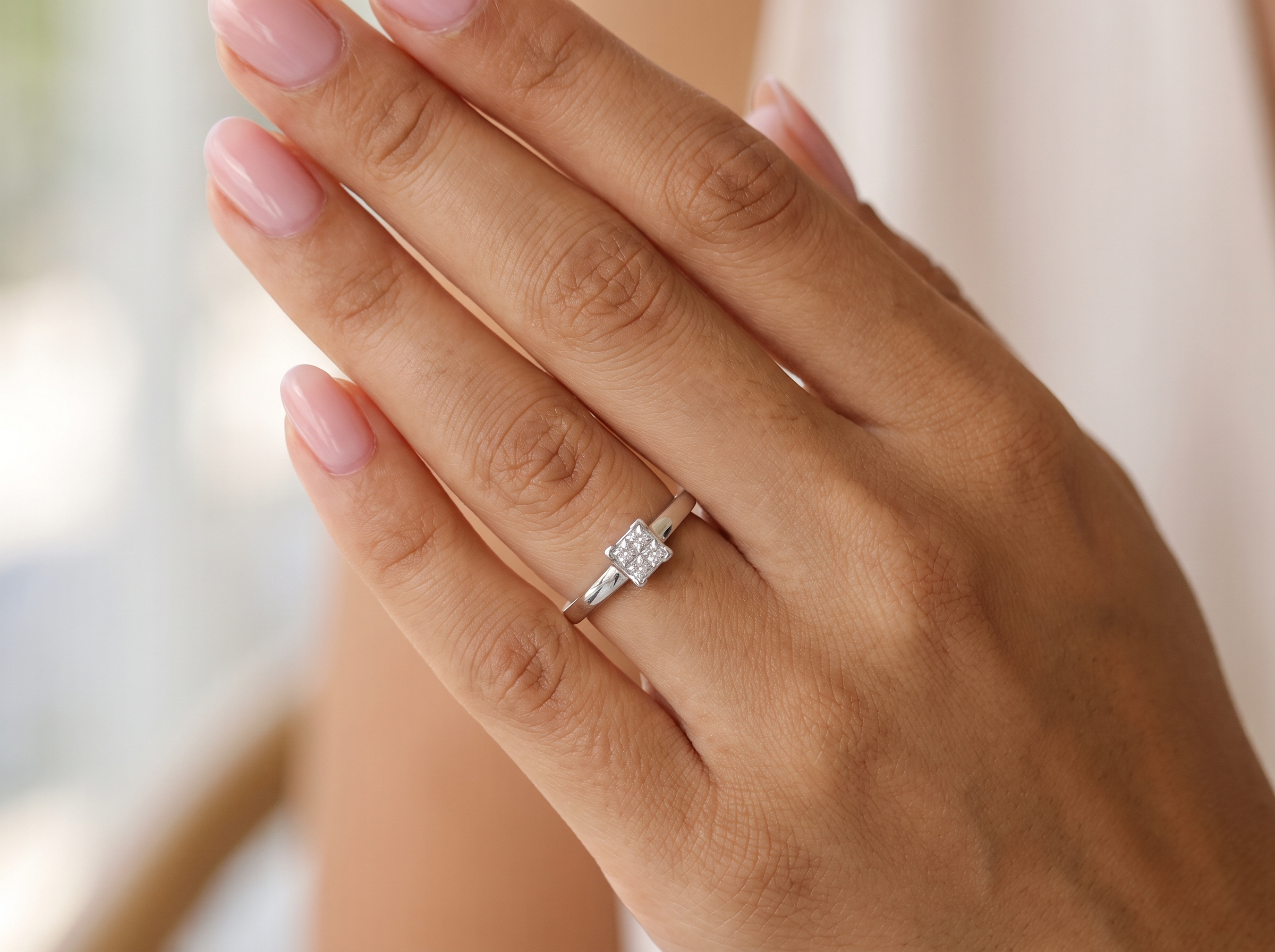 hand A stylish modern 18 carat white gold diamond cluster ring, with a beautifully clean and understated design.

The square-shaped head is set with four Princess cut white diamonds,