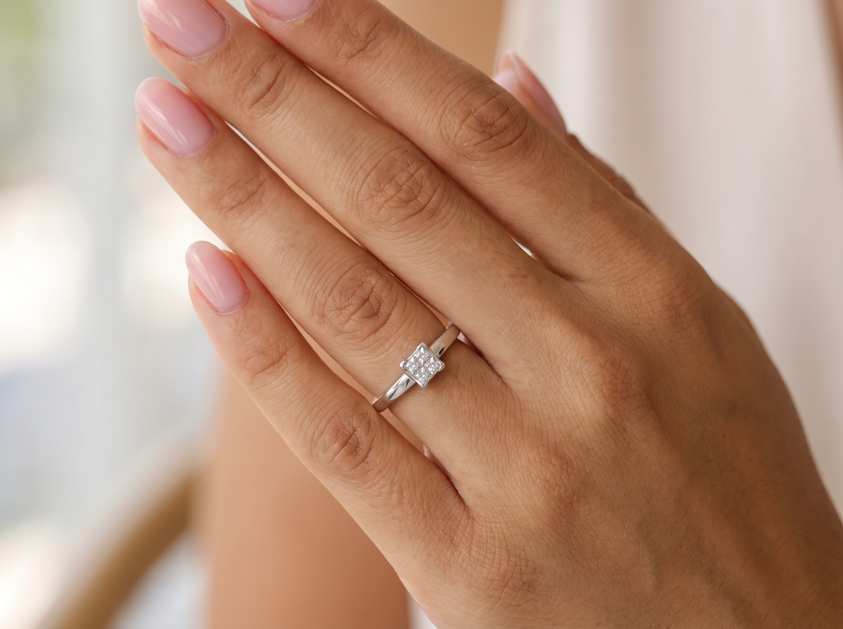 hand A stylish modern 18 carat white gold diamond cluster ring, with a beautifully clean and understated design.

The square-shaped head is set with four Princess cut white diamonds,
