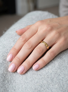 hand A traditional 18 carat gold wedding ring.

A flat to a slight D shape profile, width 3.6mm. Weight 2.2grams.
