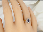 hand A traditional 1970s cluster ring featuring a&nbsp;rectangular-cut sapphire,