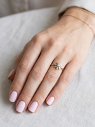hand A very pretty cluster ring, a design from the 1950s. Its daisy style was popular during this period, and set with five small white diamonds (total est. 0.05 carats) set into platinum.
