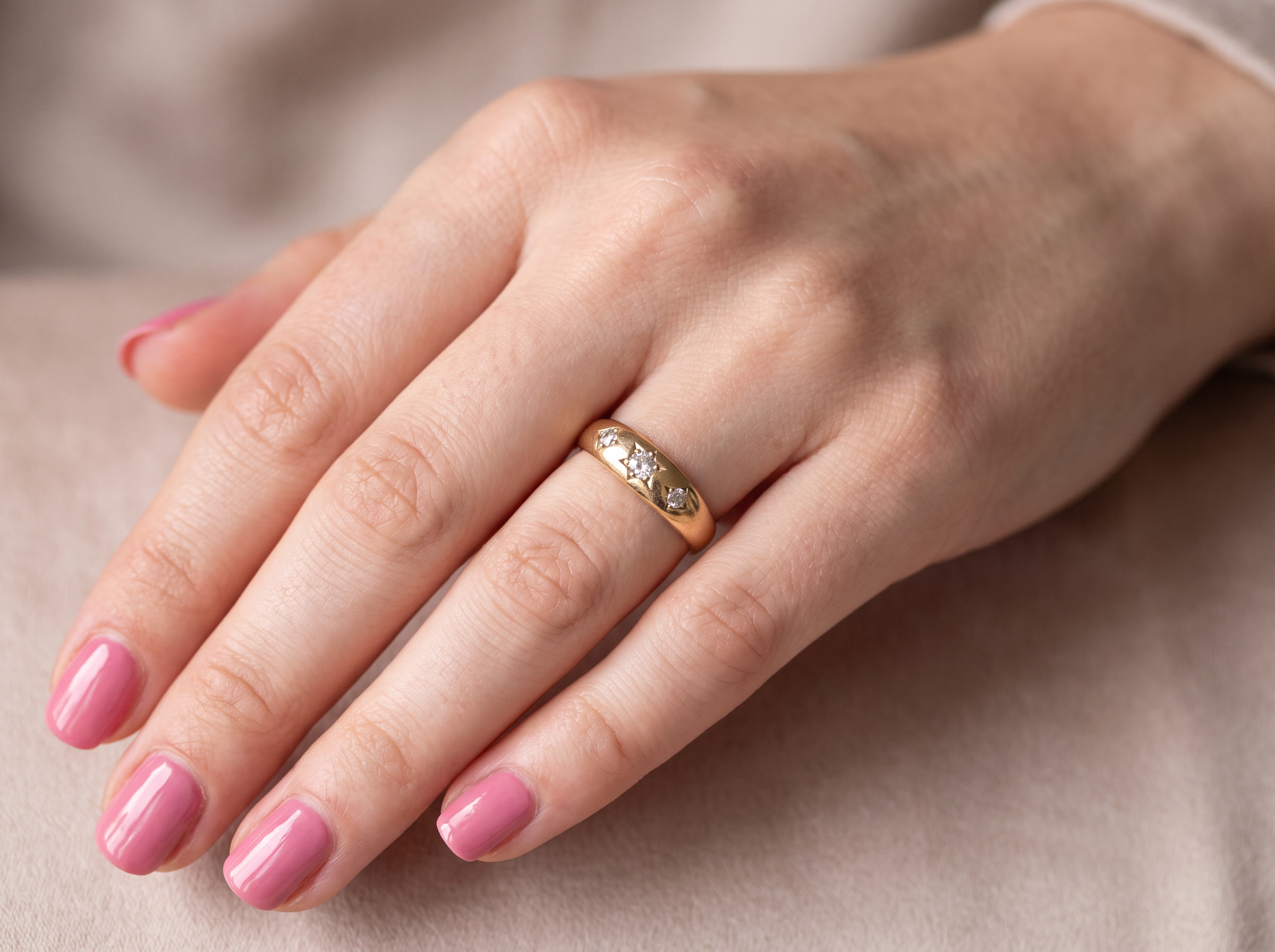 hand A vintage 18 carat gold three stone ring. Set with brilliant cut white diamonds, cente 3mm, each side a 2.4mm diamond (total est 0.20 carats) Colour I-j, clarity Si.&nbsp;
