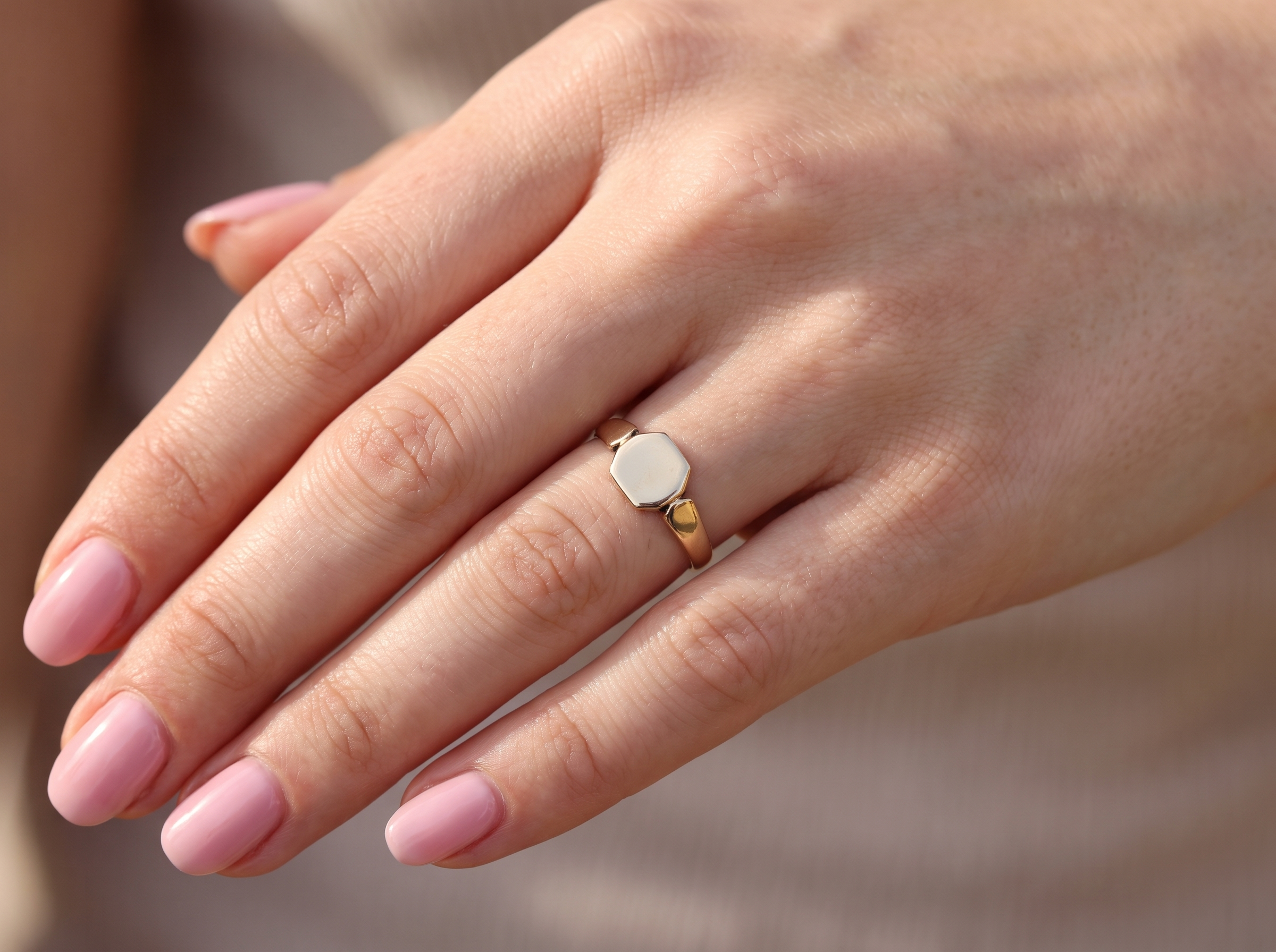 hand A vintage 9 carat gold signet ring. Six sided head shape,