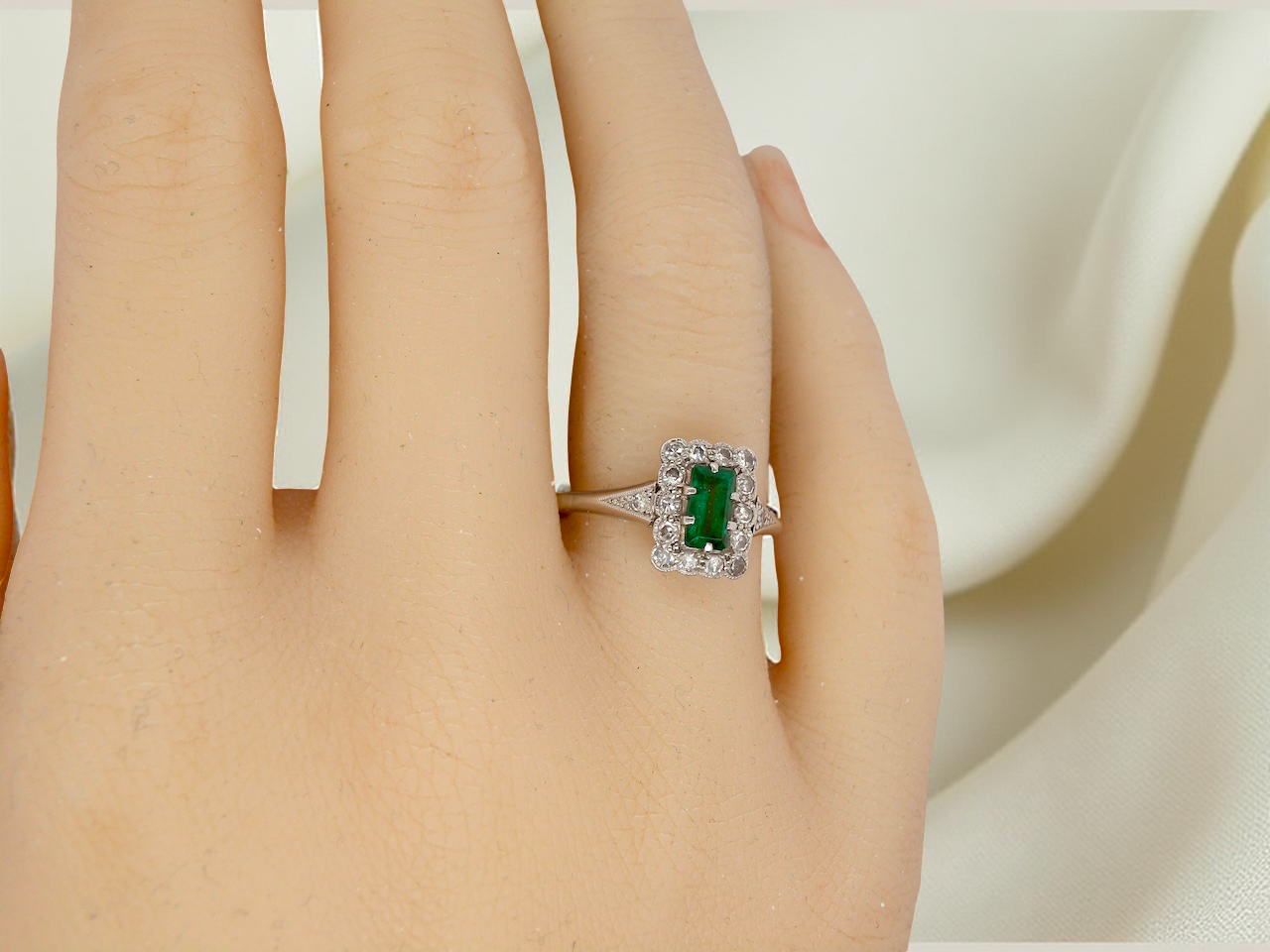 hand A vintage Emerald and Diamond Cluster ring