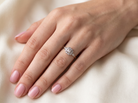 hand A vintage diamond cluster ring. Shaped like a four leaf clover, each leaf is pavé set with small white diamonds, two each x 1.5mm. Centre diamond 2.4mm. (total estimated total 0.17 carats)