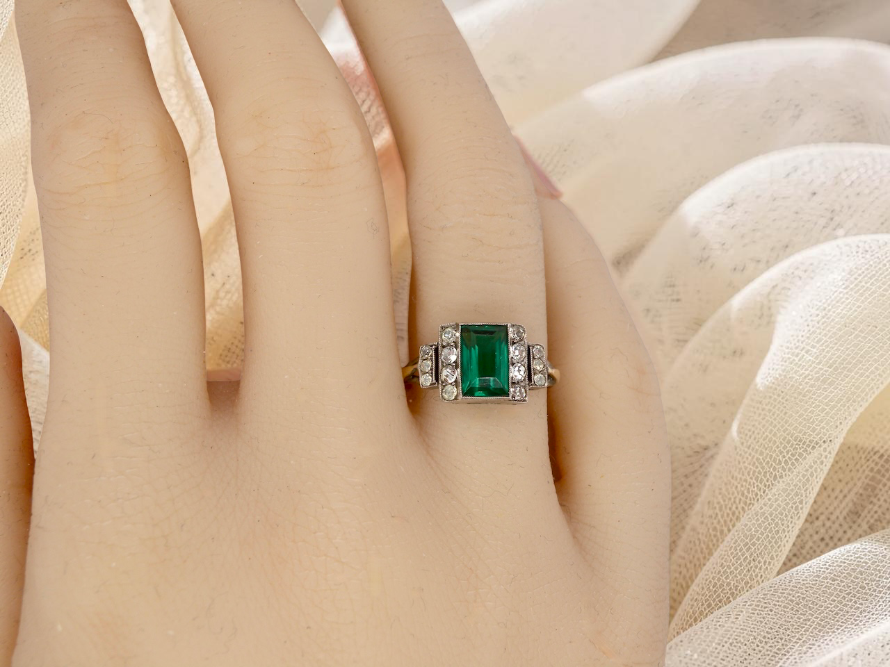 hand A vintage early 20th century dress ring. The centre stone a vibrant crystal clear green paste stone, 8x6mm.