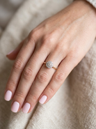 hand A vintage mid 20th century cluster ring. Principle stone a brilliant cut white diamond, 4mm (0.25 carats est) clarity i-j, clarity Si.