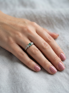 hand A vintage mid century ring. Centre stone a square emerald 3x3mm (0.15 carats est), rim setting.