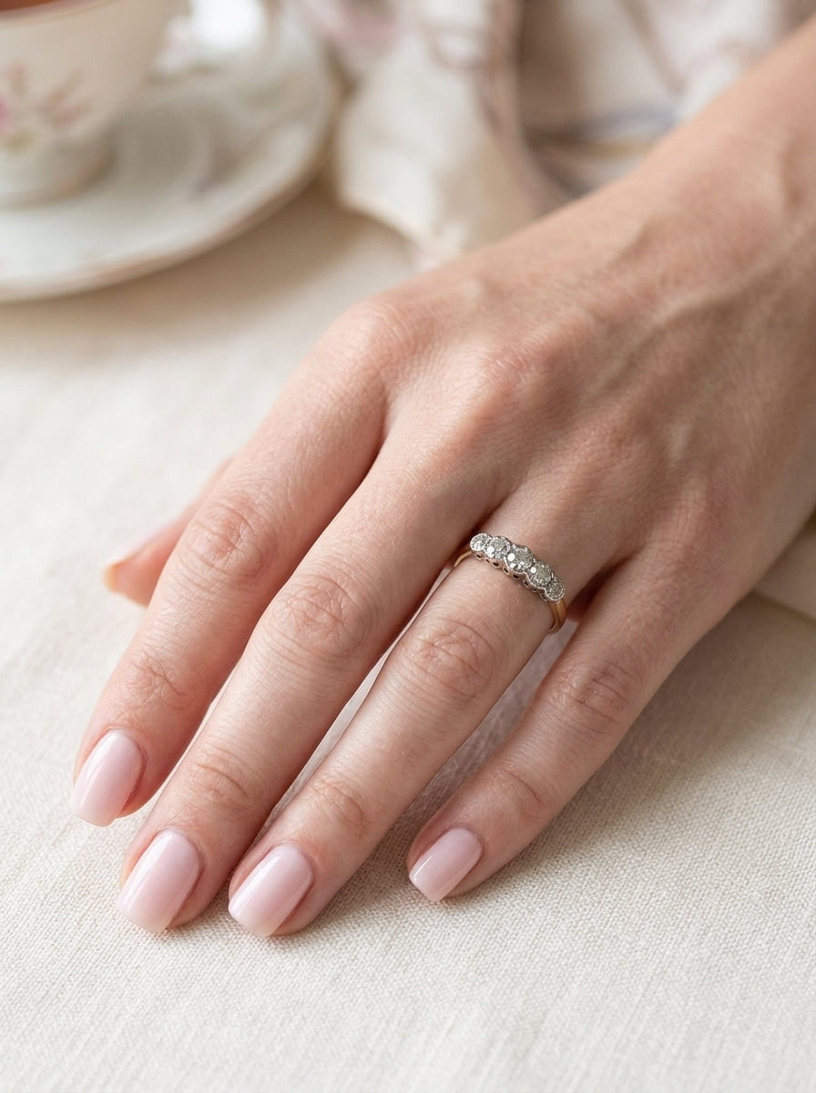 hand A vintage ring containing five old brilliant cut white diamonds. Centre 3mm, each side 2.2mm, at each end a 1.8mm diamond. Total diamond content estimated at 0.25 carats. All illusion set in platinum