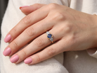 hand A vintage ring that features to the centre a substantial sapphire and to each side set in platinum three small diamonds.