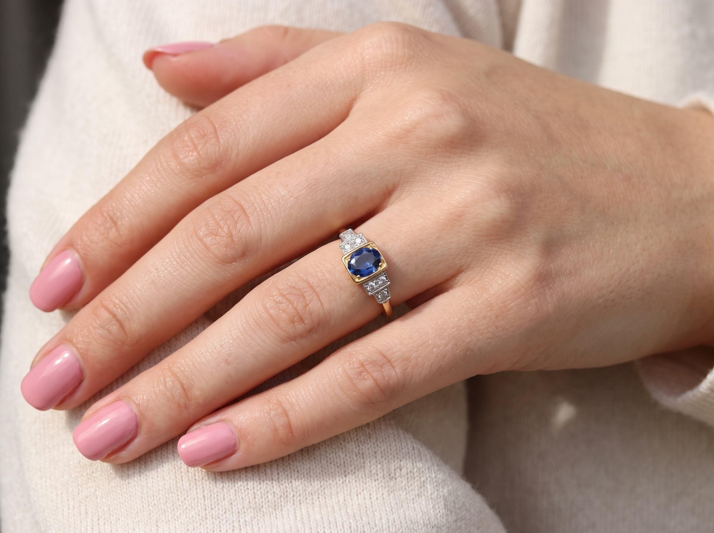 hand A vintage ring that features to the centre a substantial sapphire and to each side set in platinum three small diamonds.