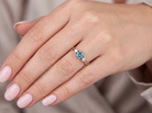 hand A vintage three stone ring. Features to the centre a 6mm natural blue zircon, 6mm diameter, claw set.