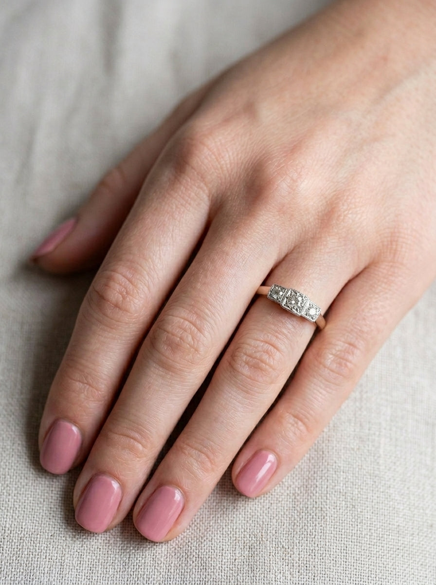 hand A vintage trilogy ring. Set with three old brilliant cut white diamonds, centre 3mm and each side a 2.4mm diamond. Total estimated at 0.20 carats, colour H-j, clarity Si
