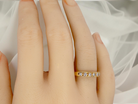 hand An 18 carat gold half-hoop eternity ring, set with eight brilliant-cut white diamonds