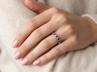 hand An 18 carat white gold half hoop eternity ring. Set with princess cut white diamonds, total of four- estimated 0.40 carats (2.4mm each) colour H-j, clarity Si.