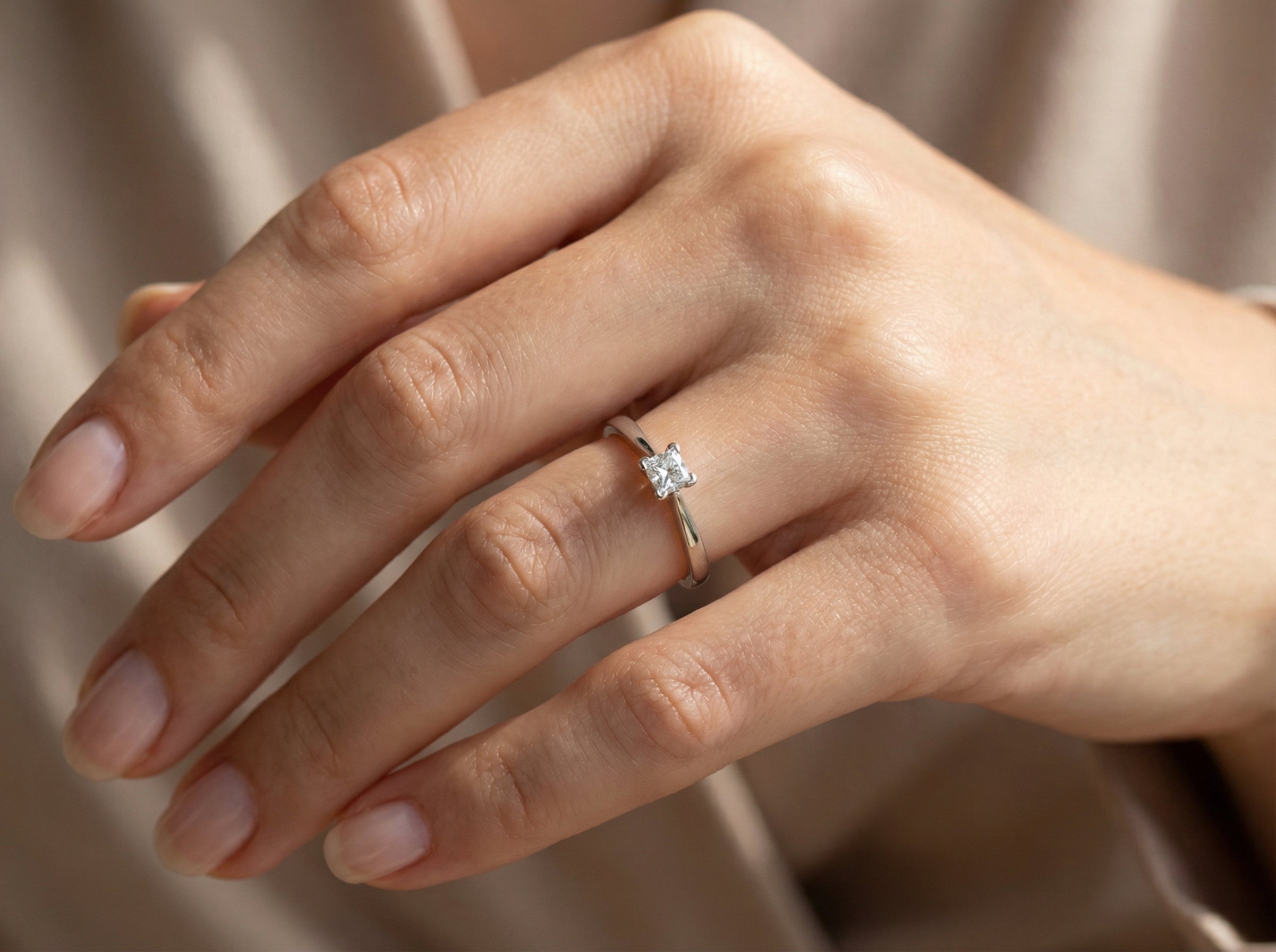 hand An 18 carat white gold solitaire ring that features a Princess Cut white diamond. Measures 4x4mm,&nbsp; (est 0.30 carats). Colour I-j, clarity Si
