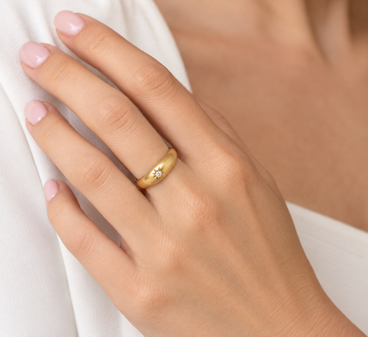 hand An 18 carat yellow gold ring, sometimes referred to as a 'gypsy' ring. The diamond measures 2.4mm (0.05 carats) star set.