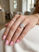 hand An Art Deco panel shaped cluster ring. The head measures 16x10mm, depth 3.4mm, and has two fan shaped designs that feature above and below a brilliant cut white diamond centre stone which measures 3.4mm (0.15 carats est)
