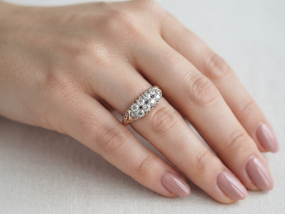 hand An eight stone boat shaped diamond ring, with two extra 'accent' diamonds to each end