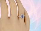 hand An elegant cluster ring that features to the centre a rectangular tanzanite gemstone that measures 6x4mm (est 0.50 carats) AAA colour.