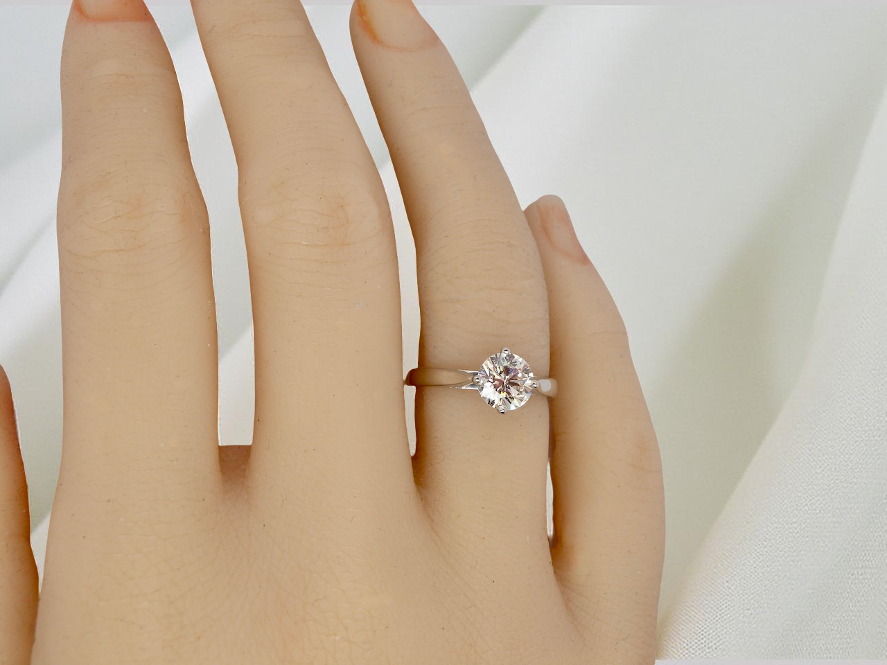 hand An impressive platinum solitaire ring set with a modern brilliant-cut white diamond.