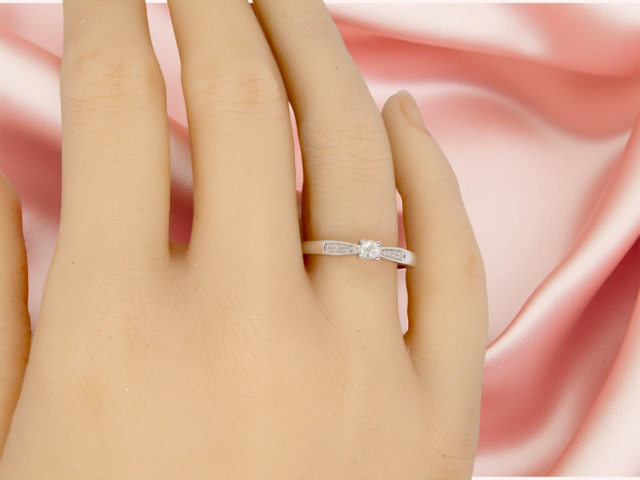 hand An&nbsp; 18 carat white gold solitaire ring set with a central round brilliant-cut diamond measuring approximately 2.8mm (0.08 carats)