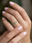 hand This ring is set with six bright green emeralds, each 2mm, (est 0.25 carats) and five 2mm brilliant cut white diamonds.