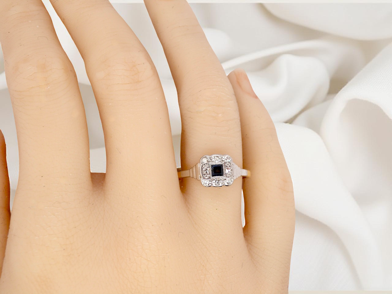 hand antique cluster ring. Features a small square sapphire