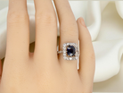 hand beautiful original Art Deco cluster ring featuring a rich, dark blue oval-cut sapphire