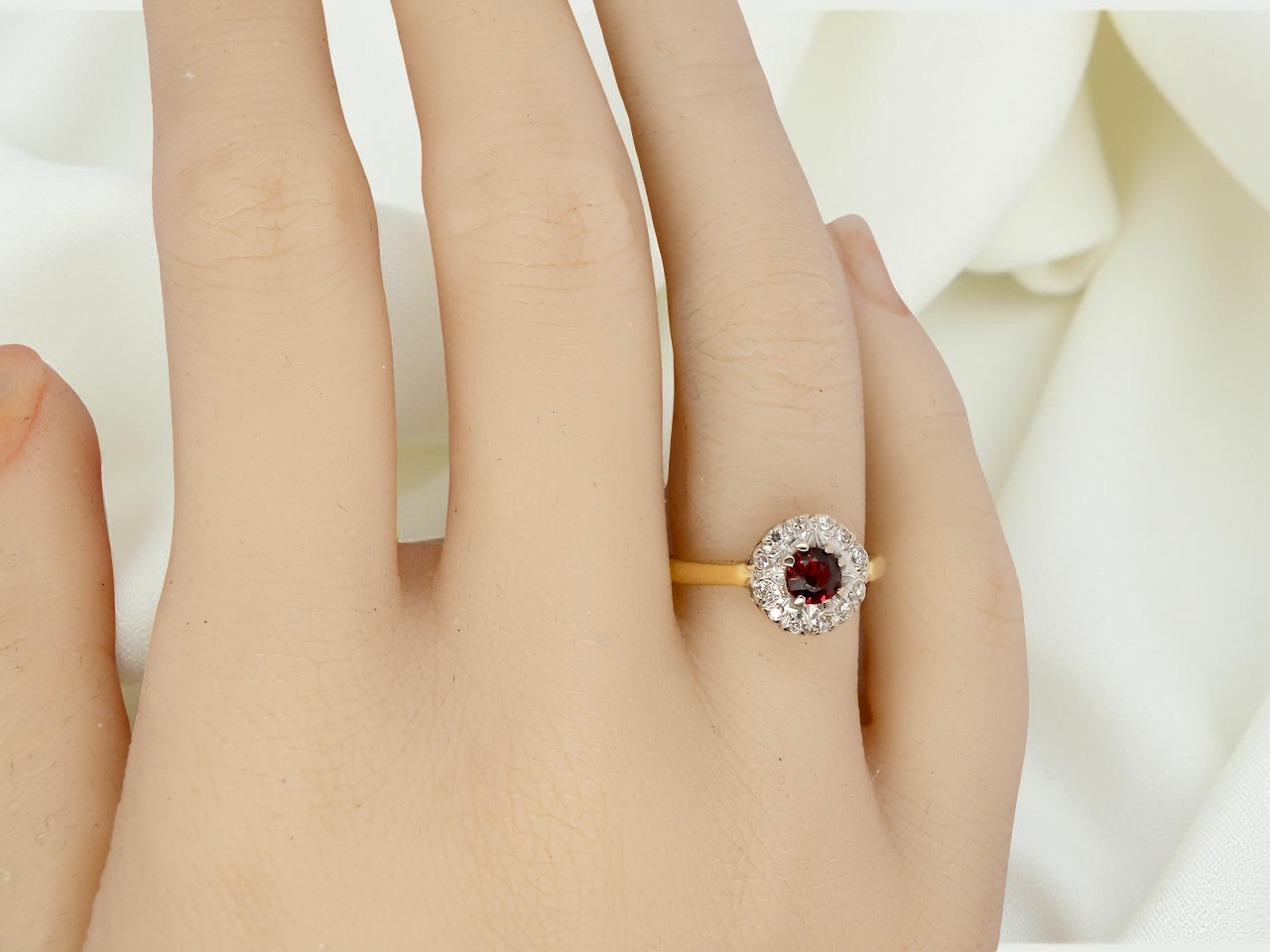 hand  classic 1960s 18 carat yellow gold cluster ring, featuring a round garnet 