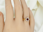 hand  classic 1960s 18 carat yellow gold cluster ring, featuring a round garnet 