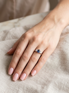 hand  classic trilogy ring set with an exquisite oval cut sapphire centre stone, hues of deep&nbsp; blue colour and measuring 6x4.2mm (est approx 0.50 carats) 