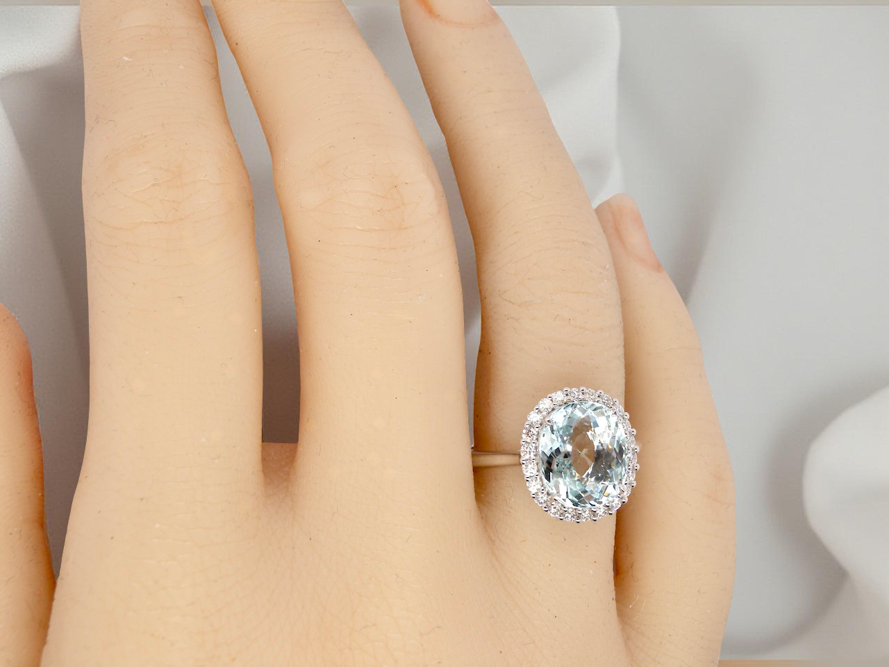 hand  elegant cluster ring centred on a beautiful oval aquamarine, 