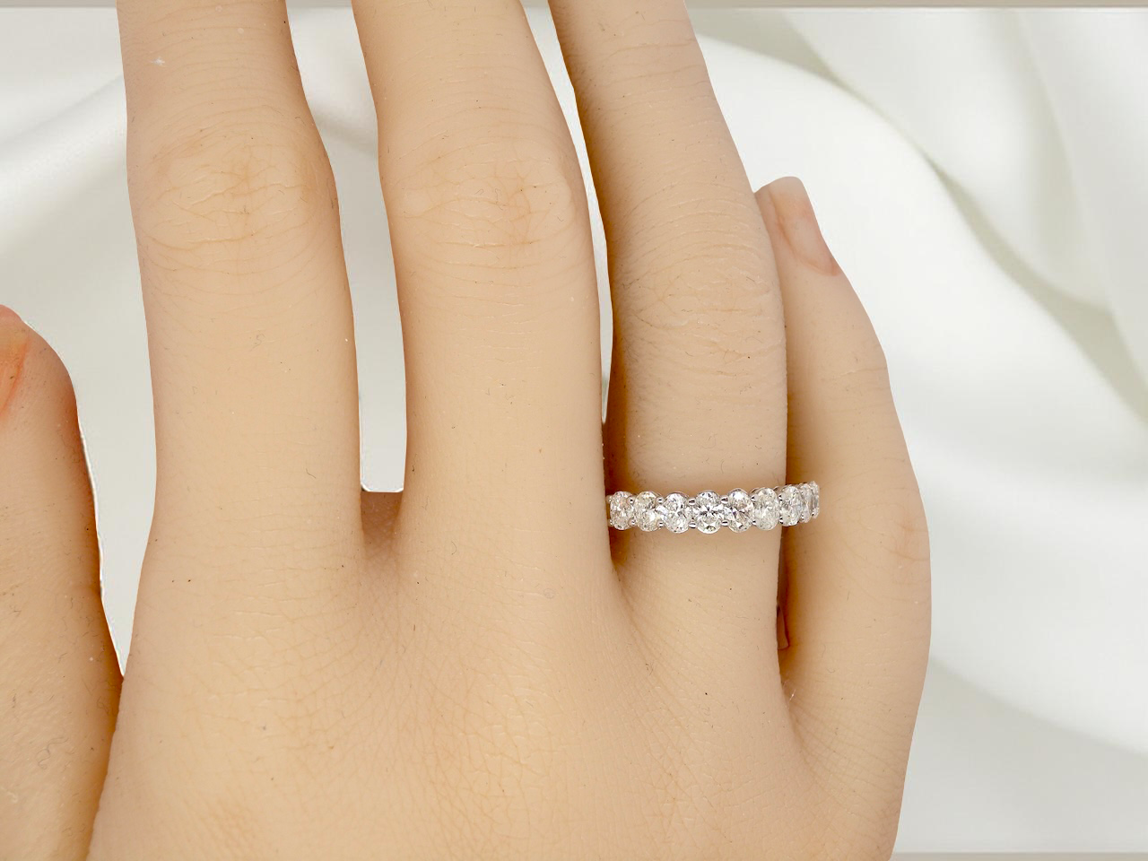 hand gorgeous half-hoop eternity ring set with nine oval brilliant-cut white diamonds.