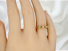 hand half-eternity ring set with alternating emeralds and diamonds.