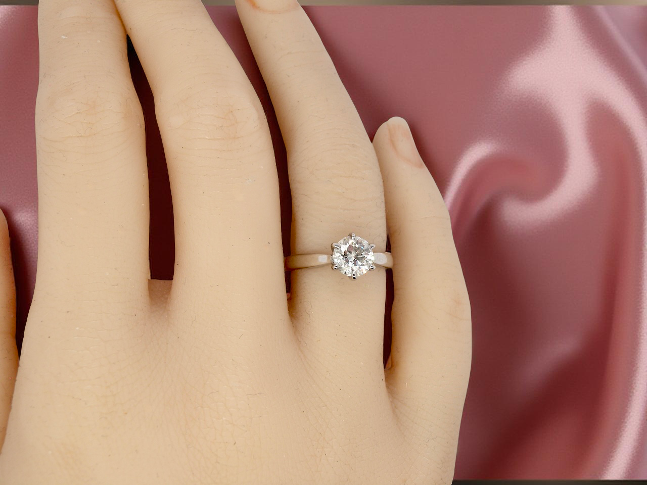 hand  iconic solitaire ring. Features an impressive brilliant cut white diamond. 