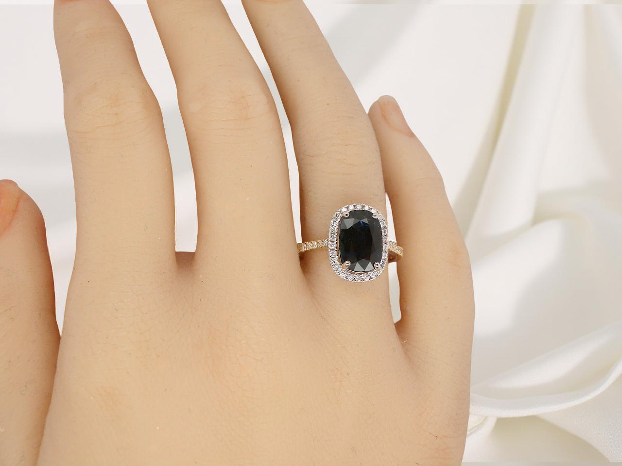 hand striking cluster ring featuring a captivating&nbsp;ink-black blue sapphire,