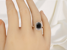 hand striking cluster ring featuring a captivating&nbsp;ink-black blue sapphire,