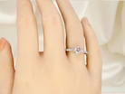hand A stunning 14-carat white gold* solitaire ring featuring a brilliant-cut white diamond.