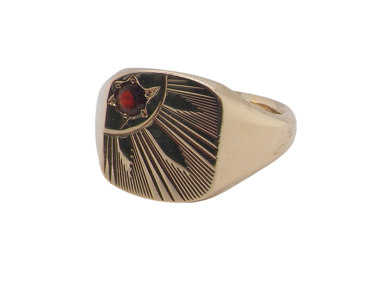 Gold ring with a red gemstone on a white background