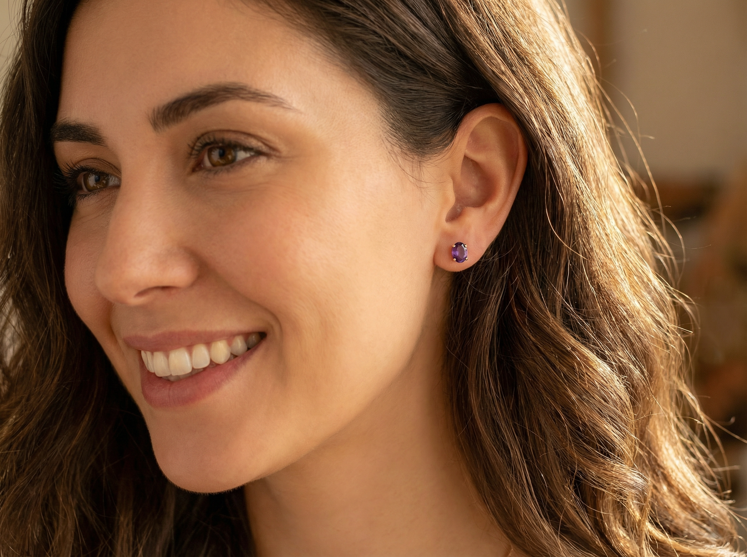 model A pair of 9 carat gold stud earrings. Each earring an oval cut amethyst stone,