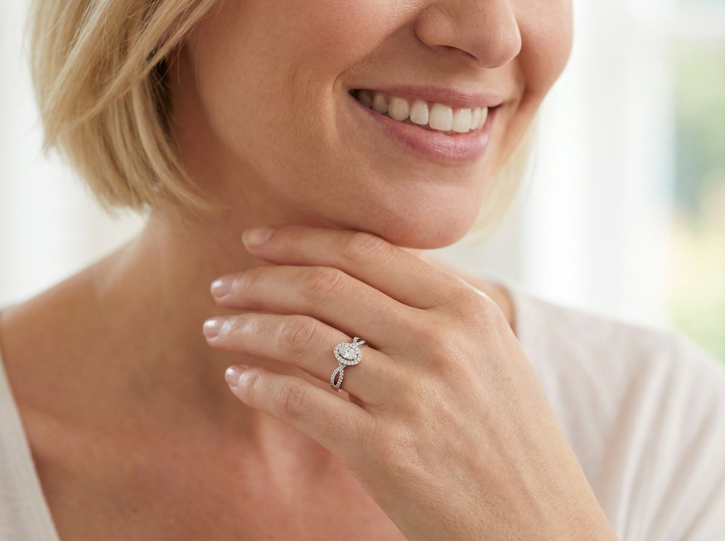 model  A 14 carat white gold cluster ring. The centre cluster an oval setting with nine small white diamonds.&nbsp;

Around the outside a halo of sixteen smaller diamonds, 