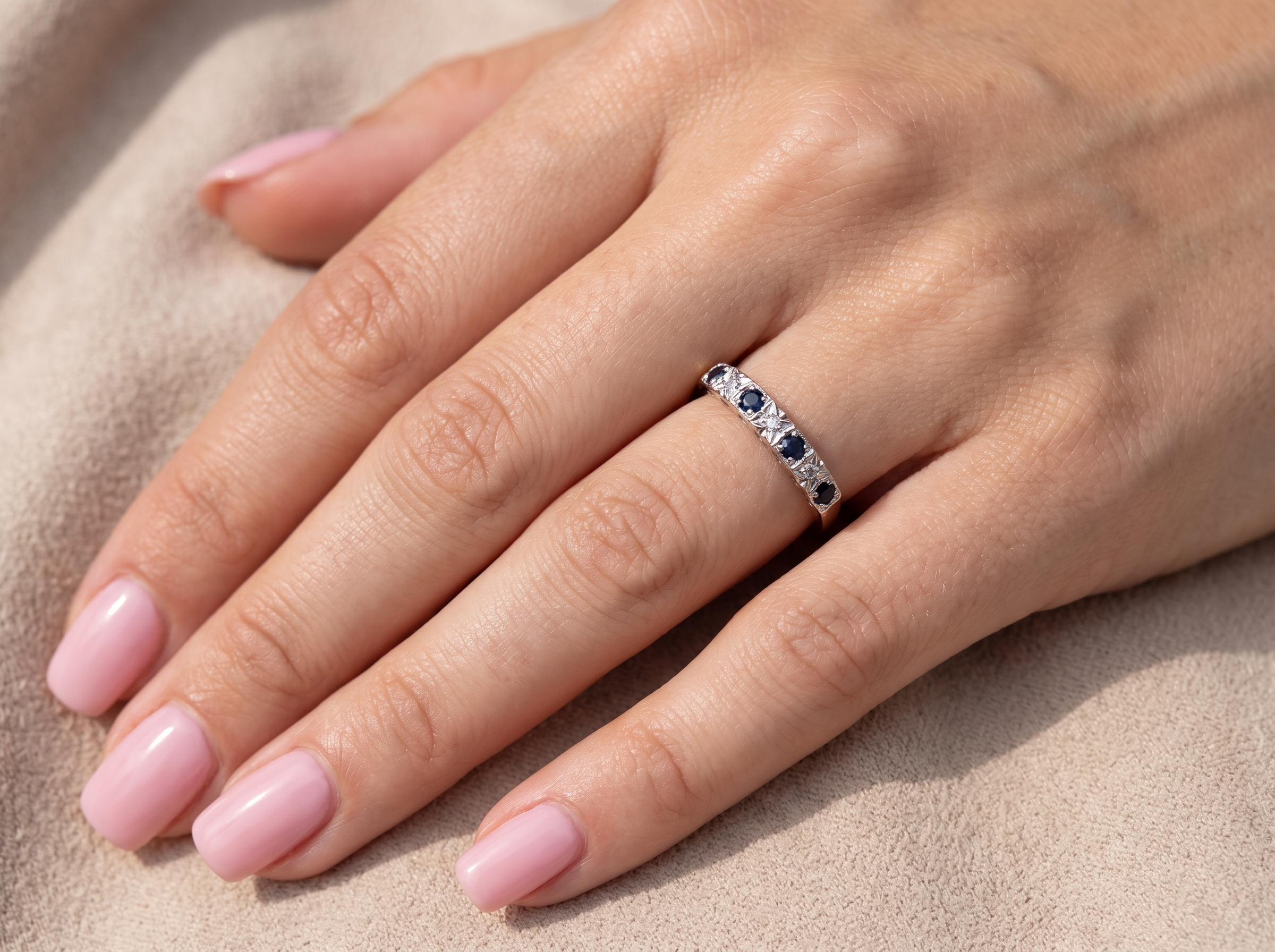 model A 9 carat gold half hoop eternity ring. Set with four sapphires, each 2.4mm, and between each a 1mm illusion set diamond.