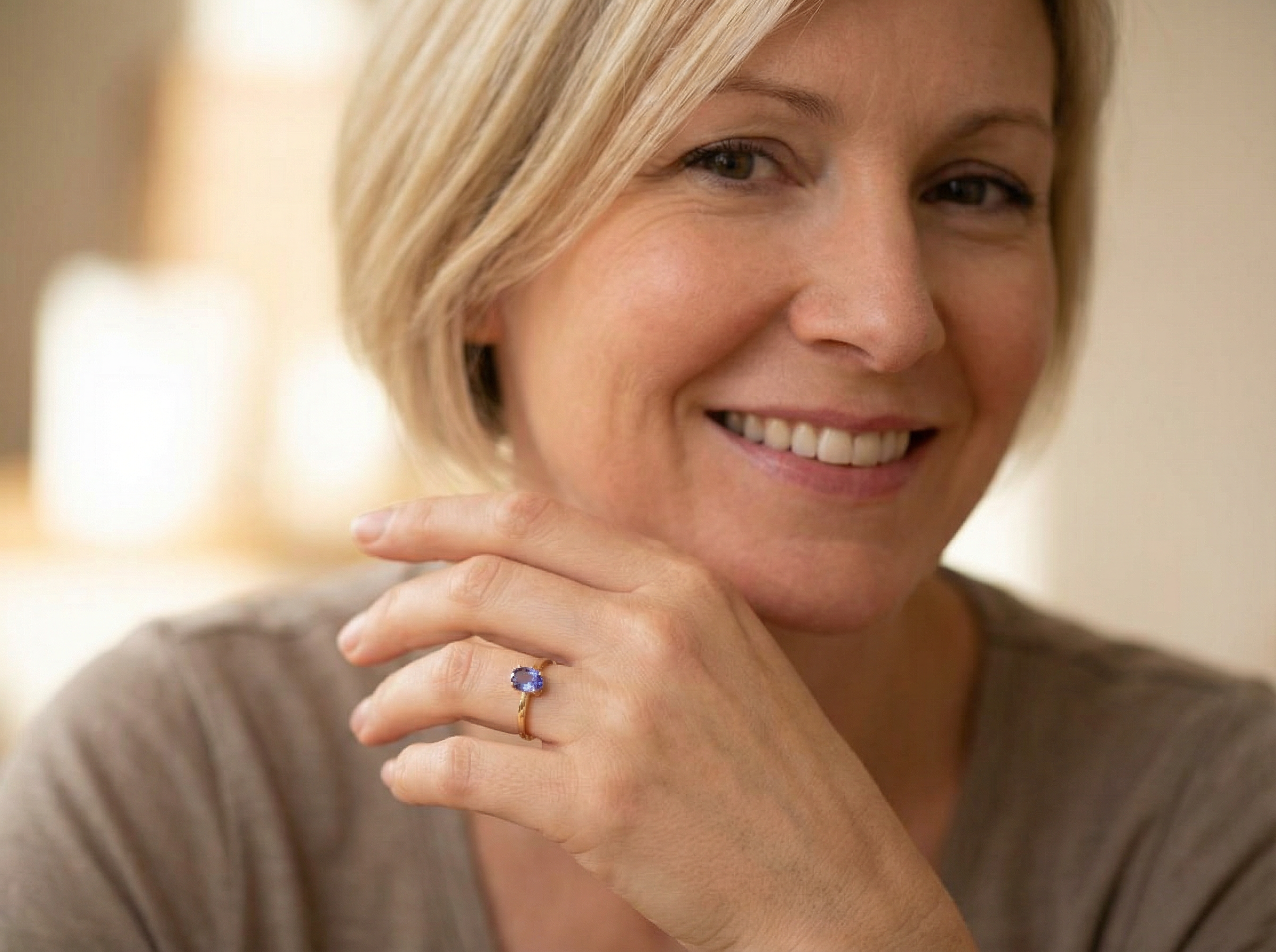 model A 9 carat gold ring containing a single oval cut tanzanite gemstone. Measures 8x6mm, four claw setting.