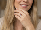 model A beautiful vintage cluster ring showcasing a vivid pink sapphire centre stone, measuring approximately 6.6 × 4.3 mm(estimated 0.65 carats).