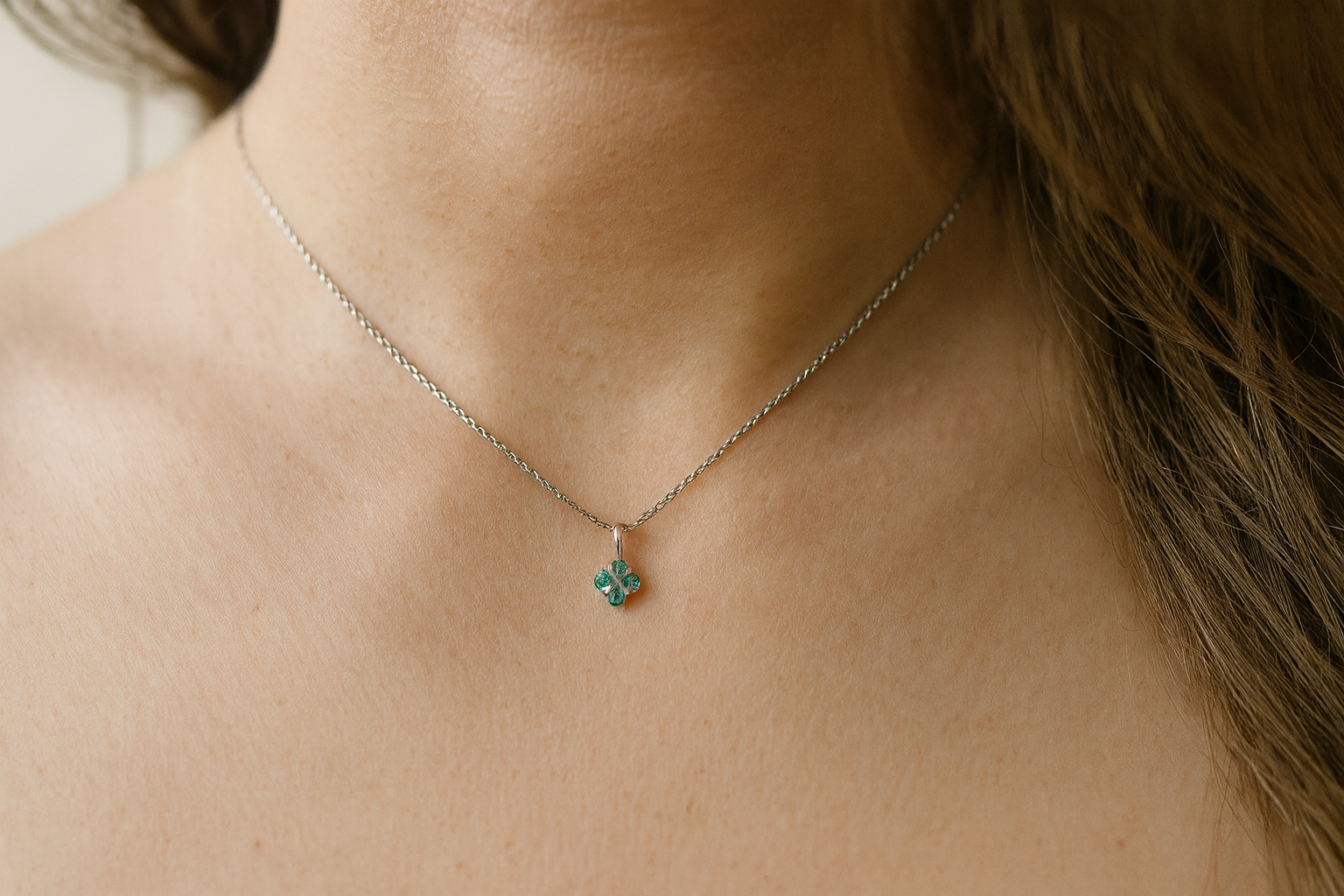 model A delicate&nbsp; pendant crafted in 18ct white gold, featuring a cluster of four round emeralds, 