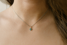 model A delicate&nbsp; pendant crafted in 18ct white gold, featuring a cluster of four round emeralds, 