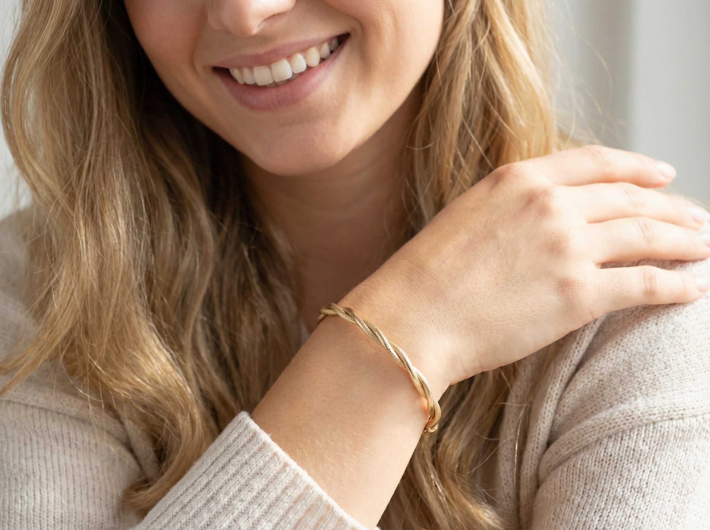 model A double twist of a plain band entwined around a filagree band to add strength and beauty to this very wearable piece of jewellery.